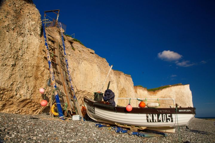 Fishing Boat below the Cliffs
